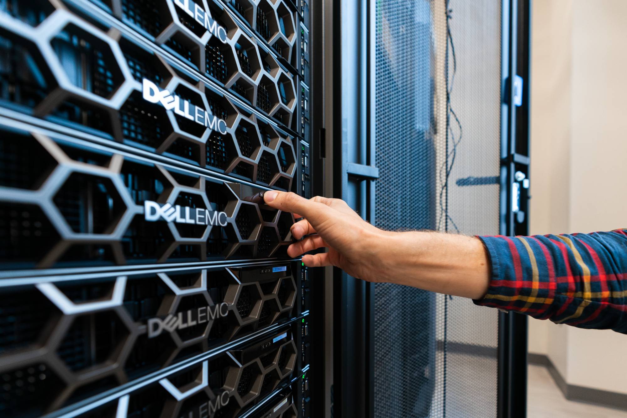 Person working on server rack.